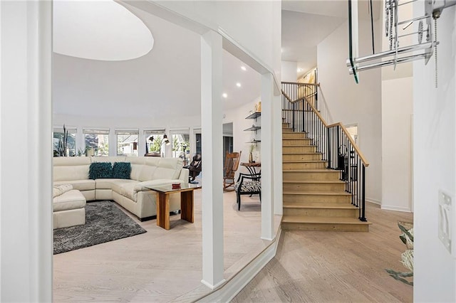 8201 W 100th Ter, Overland Park, KS 66212 - stairway featuring wood finished floors, a high ceiling, and recessed lighting