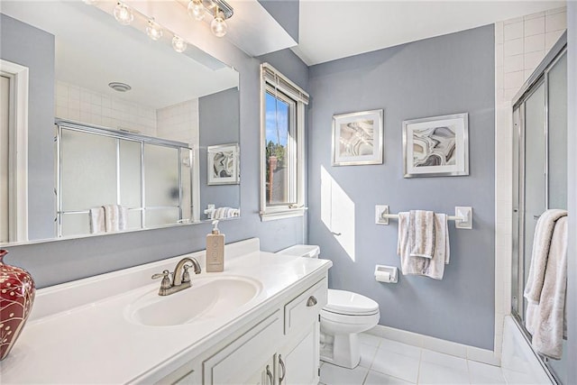 8201 W 100th Ter, Overland Park, KS 66212 - full bath with vanity, toilet, tile patterned flooring, combined bath / shower with glass door, and baseboards