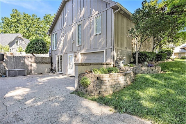 8201 W 100th Ter, Overland Park, KS 66212 - view of front facade featuring board and batten siding and a patio area