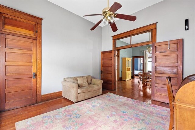 901 S 3rd St, Leavenworth, KS 66048 - sitting room with ceiling fan, wood finished floors, high vaulted ceiling, and baseboards