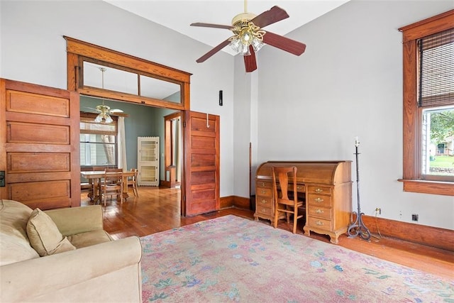 901 S 3rd St, Leavenworth, KS 66048 - living room featuring ceiling fan, wood finished floors, and baseboards