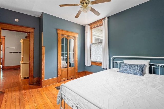 901 S 3rd St, Leavenworth, KS 66048 - bedroom with hardwood / wood-style floors, baseboards, and ceiling fan