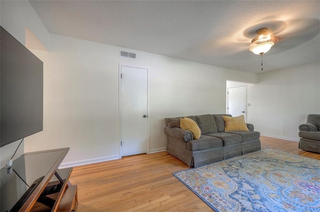 5815 W 70th St, Overland Park, KS 66208 - living area featuring light wood-style flooring, a ceiling fan, and a textured ceiling