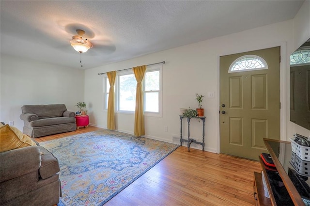 5815 W 70th St, Overland Park, KS 66208 - living area featuring plenty of natural light, light wood-style flooring, a ceiling fan, and a textured ceiling