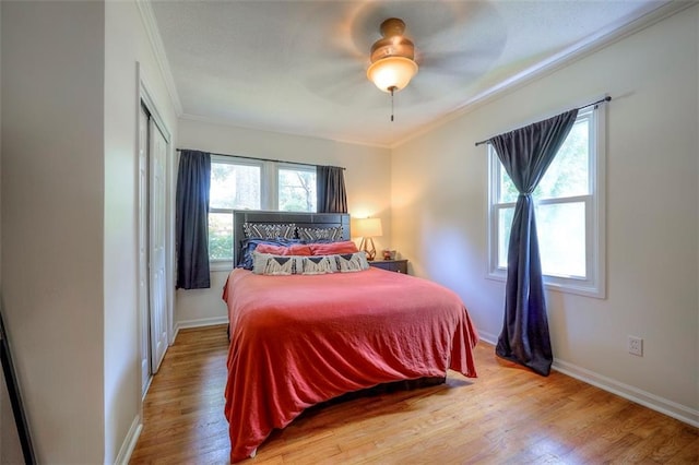 5815 W 70th St, Overland Park, KS 66208 - bedroom featuring ornamental molding, wood finished floors, ceiling fan, and a closet