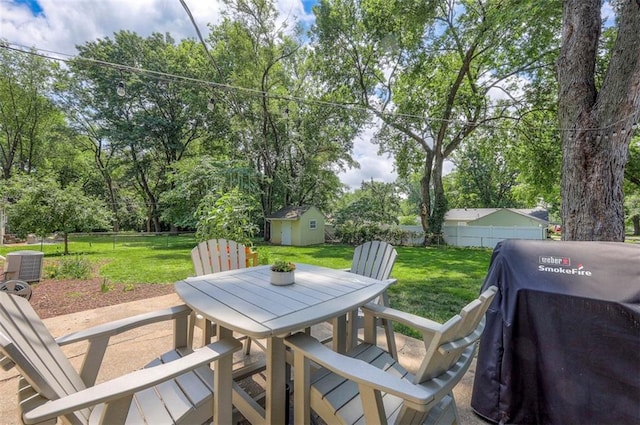 5815 W 70th St, Overland Park, KS 66208 - fenced backyard featuring outdoor dining area, a storage unit, area for grilling, and view of scattered trees