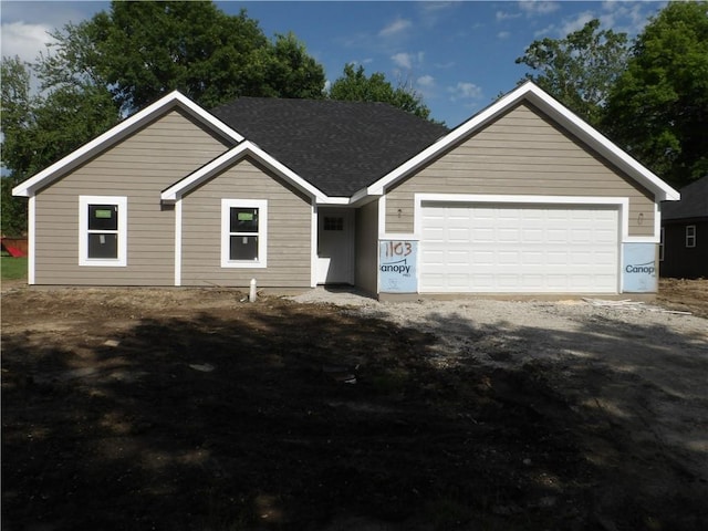 1103 S Olive St, Holden, MO 64040 - ranch-style house featuring a shingled roof