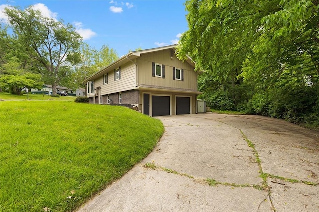3601 NW 56th St, Houston Lake, MO 64151 - view of home's exterior with an attached garage, concrete driveway, brick siding, and a lawn