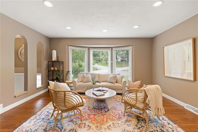 3601 NW 56th St, Houston Lake, MO 64151 - living area with arched walkways, baseboards, wood finished floors, and recessed lighting