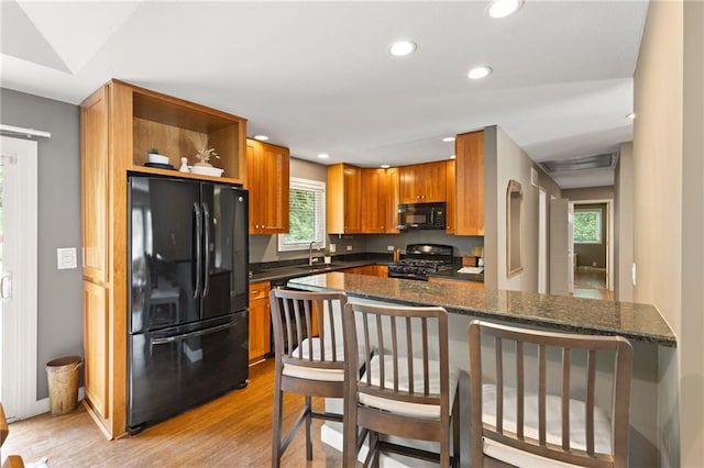 3601 NW 56th St, Houston Lake, MO 64151 - kitchen featuring black appliances, open shelves, light wood-style flooring, recessed lighting, and a sink