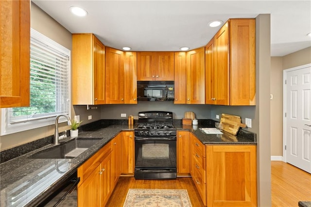 3601 NW 56th St, Houston Lake, MO 64151 - kitchen with black appliances, a sink, wood finished floors, recessed lighting, and dark stone countertops
