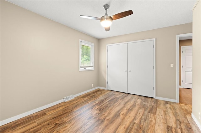 3601 NW 56th St, Houston Lake, MO 64151 - unfurnished bedroom featuring baseboards, wood finished floors, a closet, and ceiling fan
