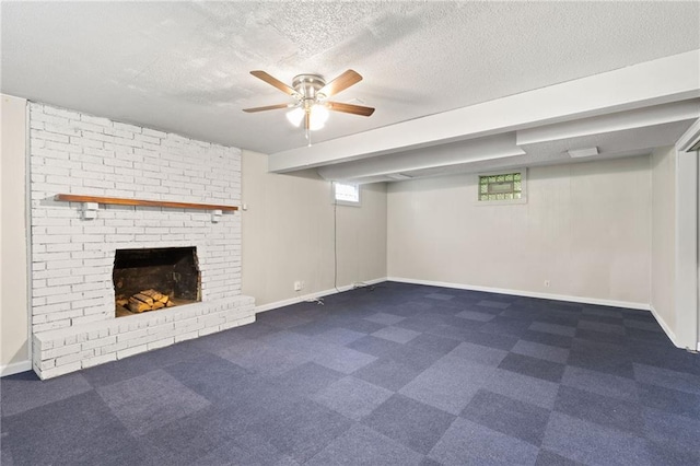 3601 NW 56th St, Houston Lake, MO 64151 - basement with a fireplace, ceiling fan, a textured ceiling, baseboards, and dark carpet