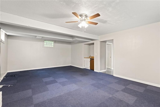 3601 NW 56th St, Houston Lake, MO 64151 - basement with baseboards, ceiling fan, a textured ceiling, and dark colored carpet
