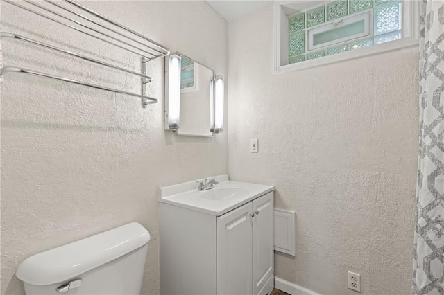3601 NW 56th St, Houston Lake, MO 64151 - bathroom featuring toilet, vanity, and a textured wall