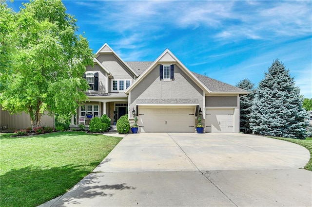 24139 W 124th Ter, Olathe, KS 66061 - view of front of house featuring a front lawn, driveway, a garage, and stucco siding