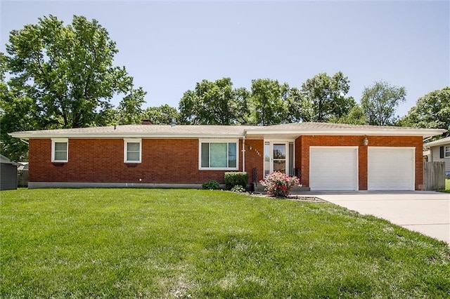 1501 Osage St, Leavenworth, KS 66048 - ranch-style house featuring a garage, driveway, brick siding, and a front lawn