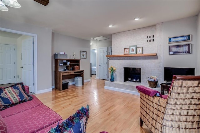 1501 Osage St, Leavenworth, KS 66048 - living room featuring light wood-style flooring, recessed lighting, baseboards, a brick fireplace, and ceiling fan