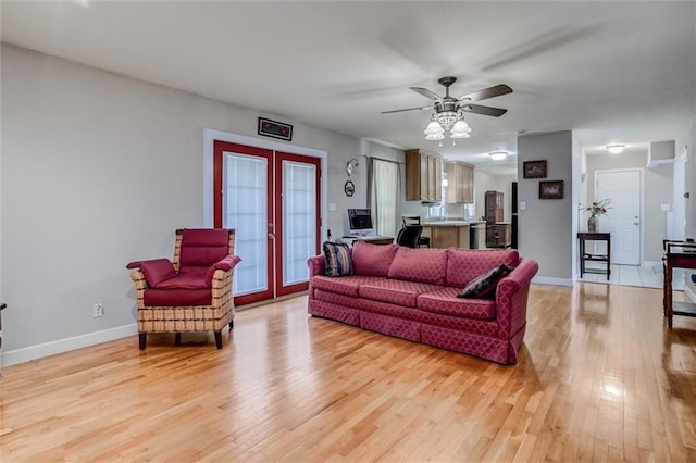 1501 Osage St, Leavenworth, KS 66048 - living room with french doors, light wood-type flooring, baseboards, and ceiling fan