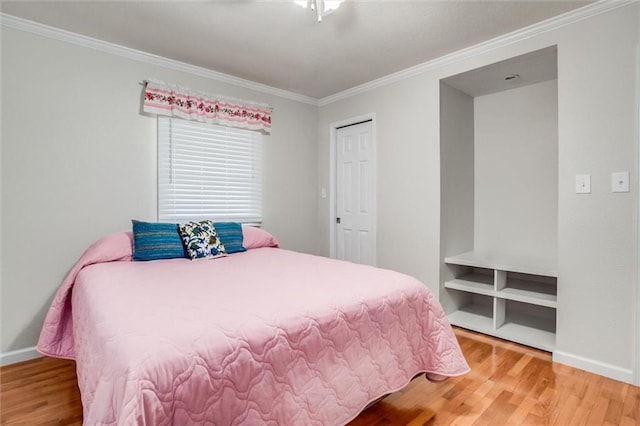 1501 Osage St, Leavenworth, KS 66048 - bedroom with wood finished floors, crown molding, baseboards, and a closet