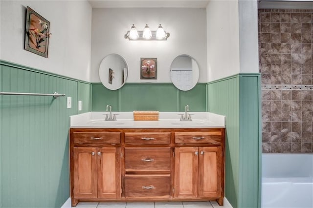 1501 Osage St, Leavenworth, KS 66048 - full bathroom featuring double vanity, wainscoting, tile patterned floors, a decorative wall, and shower / tub combination