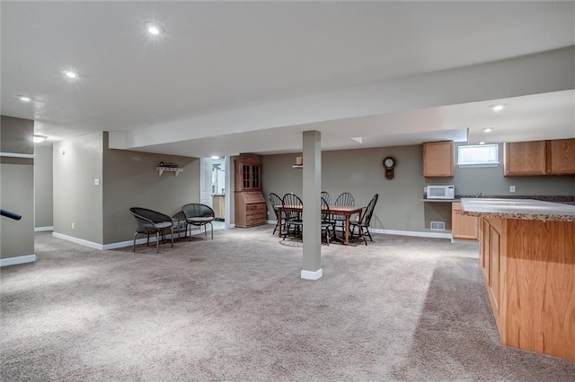 1501 Osage St, Leavenworth, KS 66048 - kitchen with baseboards, light carpet, white microwave, and recessed lighting