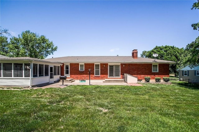 1501 Osage St, Leavenworth, KS 66048 - back of house featuring entry steps, a patio area, a chimney, and a lawn