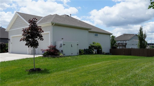 6418 N 141st St, Basehor, KS 66007 - view of side of home featuring an attached garage, driveway, and roof with shingles