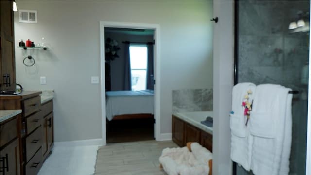 6418 N 141st St, Basehor, KS 66007 - ensuite bathroom featuring a bath, baseboards, wood finished floors, and a shower with door