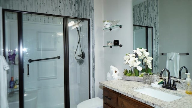6418 N 141st St, Basehor, KS 66007 - bathroom featuring vanity, a stall shower, toilet, and wallpapered walls