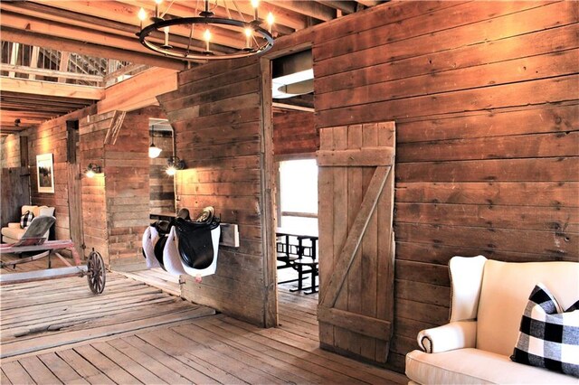 20400 280th Trl, Malta Bend, MO 65339 - sitting room featuring wooden walls, hardwood / wood-style floors, and a chandelier