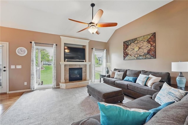 10136 N Wallace Ave, Kansas City, MO 64157 - living room featuring a ceiling fan, a fireplace, wood finished floors, lofted ceiling, and baseboards