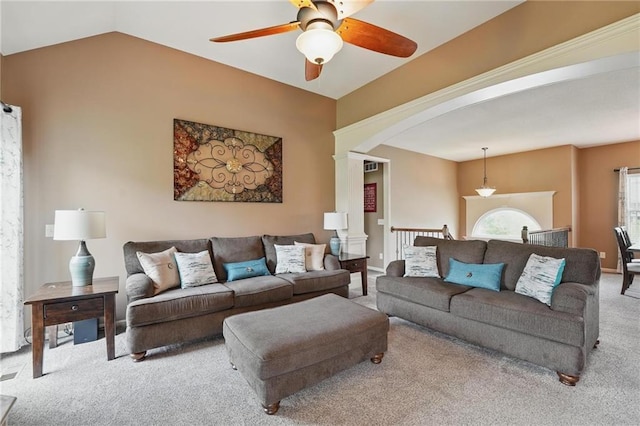 10136 N Wallace Ave, Kansas City, MO 64157 - carpeted living room featuring decorative columns, a ceiling fan, arched walkways, and lofted ceiling