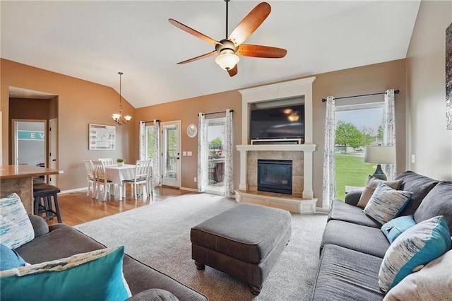 10136 N Wallace Ave, Kansas City, MO 64157 - living room with vaulted ceiling, healthy amount of natural light, a ceiling fan, a chandelier, and a fireplace
