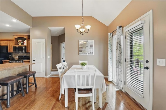 10136 N Wallace Ave, Kansas City, MO 64157 - dining area with a chandelier, lofted ceiling, light wood-style flooring, and baseboards