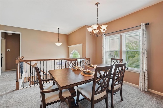 10136 N Wallace Ave, Kansas City, MO 64157 - dining area featuring light colored carpet, baseboards, and a chandelier