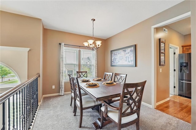 10136 N Wallace Ave, Kansas City, MO 64157 - dining space with light carpet, healthy amount of natural light, a chandelier, and baseboards