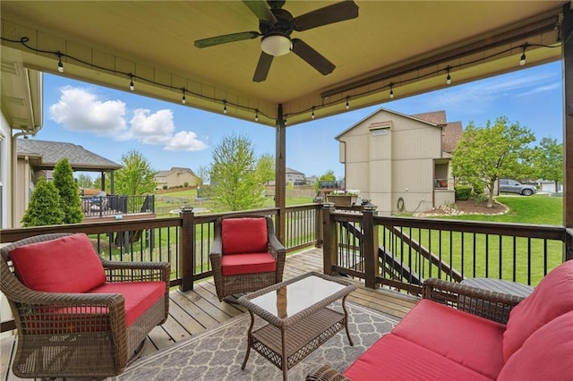 10136 N Wallace Ave, Kansas City, MO 64157 - wooden terrace featuring ceiling fan, outdoor lounge area, a lawn, and a residential view