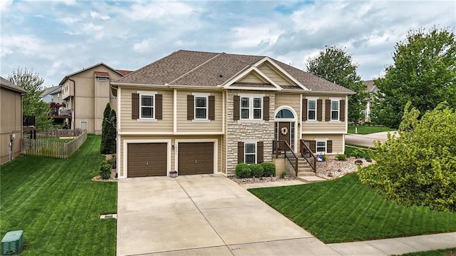 10136 N Wallace Ave, Kansas City, MO 64157 - raised ranch with a garage, concrete driveway, stone siding, and roof with shingles