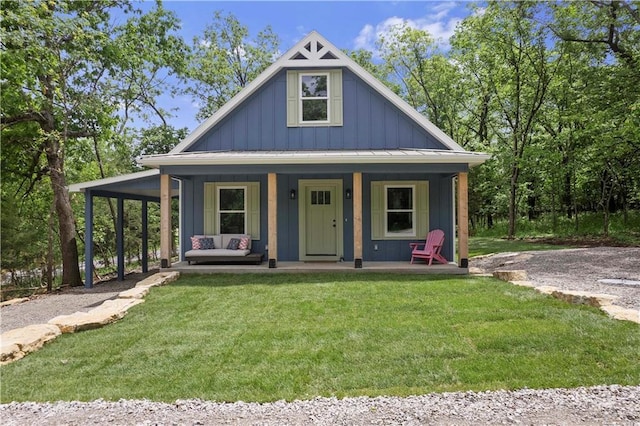18 Beechwood Ln, Linn Valley, KS 66040 - view of front facade with board and batten siding, a front yard, a porch, and metal roof