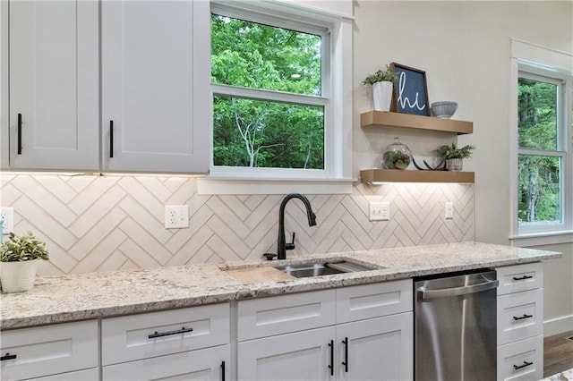 18 Beechwood Ln, Linn Valley, KS 66040 - kitchen featuring stainless steel dishwasher, a sink, white cabinetry, and backsplash