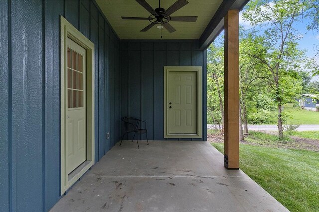 18 Beechwood Ln, Linn Valley, KS 66040 - doorway to property with ceiling fan, a patio, a yard, and board and batten siding