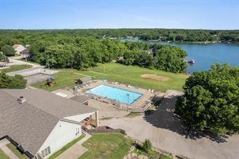 18 Beechwood Ln, Linn Valley, KS 66040 - aerial view of a large body of water, a pool area, and a heavily wooded area
