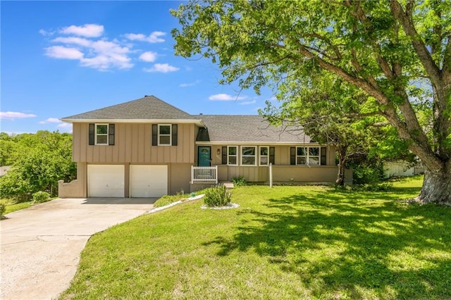 10908 Indiana Ave, Kansas City, MO 64137 - split level home featuring an attached garage, driveway, board and batten siding, roof with shingles, and a front lawn
