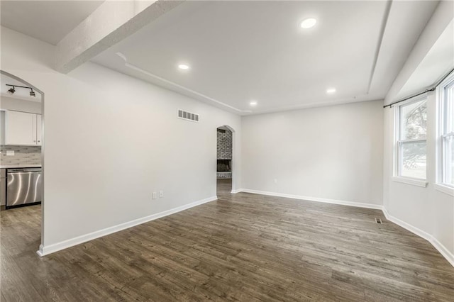 10908 Indiana Ave, Kansas City, MO 64137 - spare room with arched walkways, recessed lighting, dark wood finished floors, and baseboards