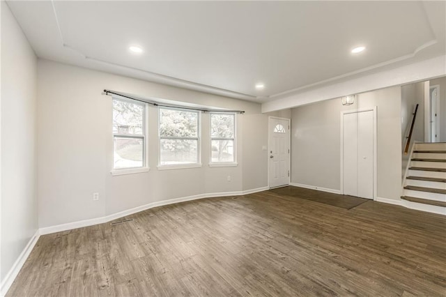 10908 Indiana Ave, Kansas City, MO 64137 - foyer entrance featuring wood finished floors, stairs, baseboards, and recessed lighting
