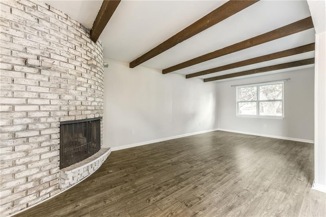 10908 Indiana Ave, Kansas City, MO 64137 - unfurnished living room with beamed ceiling, a fireplace, wood finished floors, and baseboards
