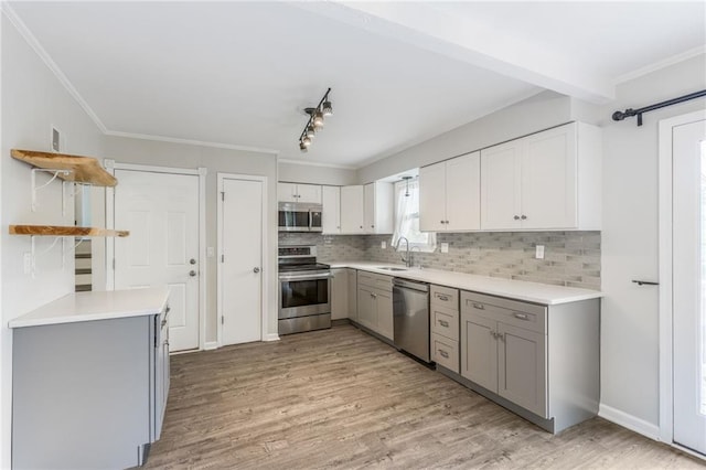 10908 Indiana Ave, Kansas City, MO 64137 - kitchen with stainless steel appliances, open shelves, a sink, gray cabinetry, and decorative backsplash