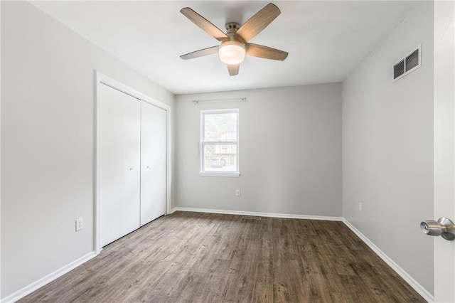 10908 Indiana Ave, Kansas City, MO 64137 - unfurnished bedroom with wood finished floors, a closet, and baseboards