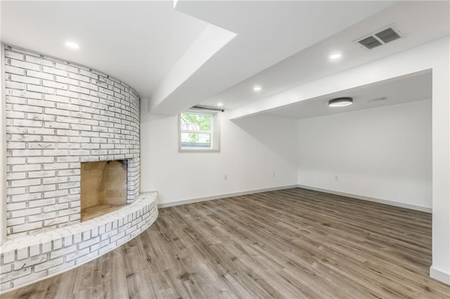 10908 Indiana Ave, Kansas City, MO 64137 - unfurnished living room featuring wood finished floors, baseboards, and a fireplace